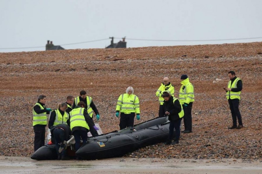 Border Force officials carry an intercepted migrant dinghy off the Kent coast ( Reuters )Border Force officials carry an intercepted migrant dinghy off the Kent coast - Reuters