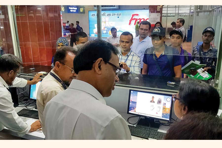 Migrants verify their documents at a migrant welfare desk in Dhaka's Hazrat Shahjahal International Airport.            —Photo: IOM   