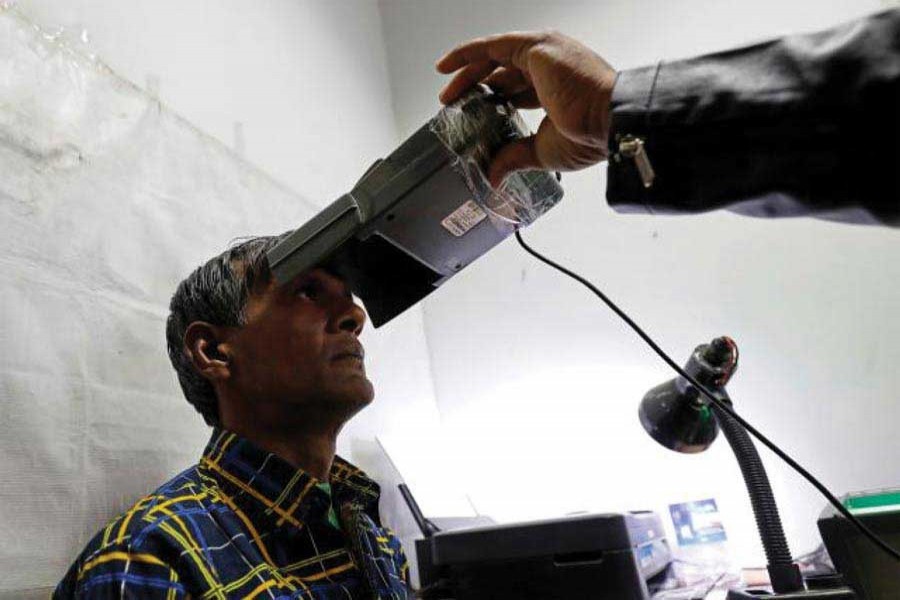 A man goes through the process of eye scanning for Aadhaar, India's national government database, at a registration centre in New Delhi  on  January  17, 2018. 	—Photo:  Reuters