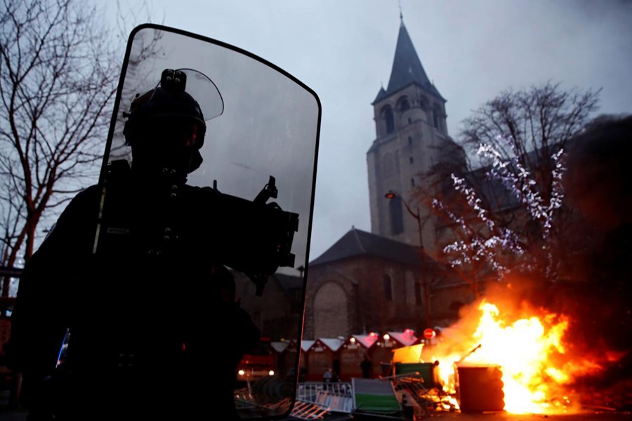 Fire is seen near a Christmas market during a demonstration by the "yellow vests" movement at Boulevard Saint Germain in Paris, France, January 5, 2019. Reuters