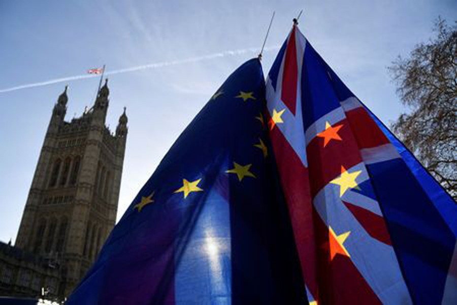 Demonstrators hold EU and Union flags during an anti-Brexit protest opposite the Houses of Parliament in London, Britain, December 17, 2018. Reuters/Files