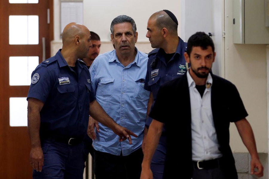 Gonen Segev, a former Israeli cabinet minister indicted on suspicion of spying for Iran, is escorted by prison guards as he arrives to court in Jerusalem, July 5, 2018 - REUTERS/Ronen Zvulun/ FILE PHOTO