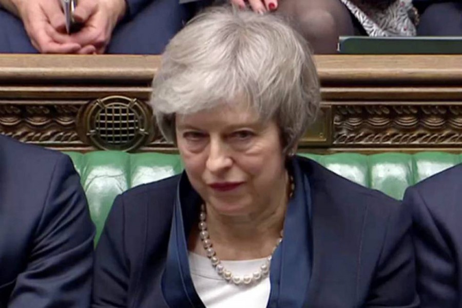 Britan's Prime Minister Theresa May sits down in Parliament after the vote on the Brexit deal, in London Britain on Tuesday in this screengrab taken from video — Reuters TV via Reuters