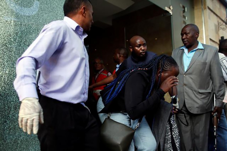 A woman is evacuated at the scene where explosions and gunshots were heard at the Dusit hotel compound, in Nairobi, Kenya on Tuesday — Reuters photo
