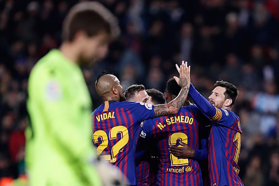 Barca players gather around Ousmane Dembele after he scored the team's second goal — AP photo