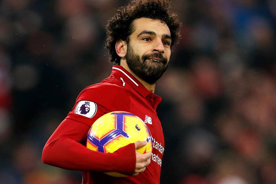 Salah brace helps 10-man Liverpool avoid defeat