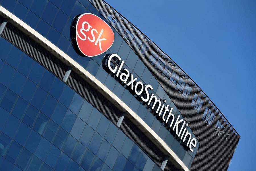 FILE PHOTO: Signage for GlaxoSmithKline is seen on its offices in London, Britain, March 30, 2016 - REUTERS/Toby Melville/File Photo