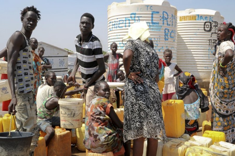 In this photo taken Tuesday, Jan 22, 2019, residents of the Mangateen camp for the internally-displaced line up to get water from a borehole, on the outskirts of the capital Juba, South Sudan. Tens of thousands of people are still sheltering in United Nations protected camps across the country, the legacy of an unprecedented decision by a UN peacekeeping mission to throw open its doors to people fleeing war. - AP Photo