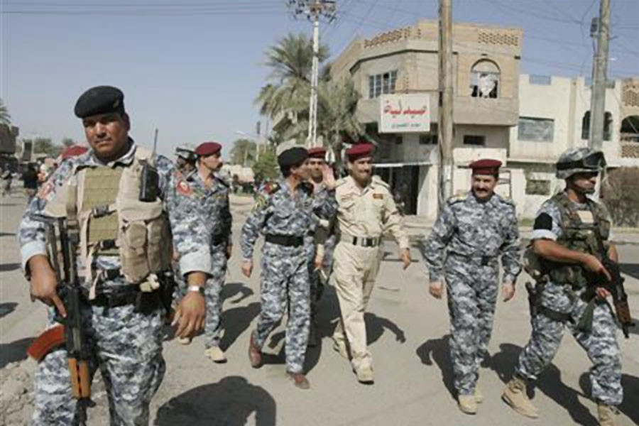 Iraqi police officers walk in Baghdad's Sunni district of al-Khadra October 25, 2007- Reuters photo used for representation