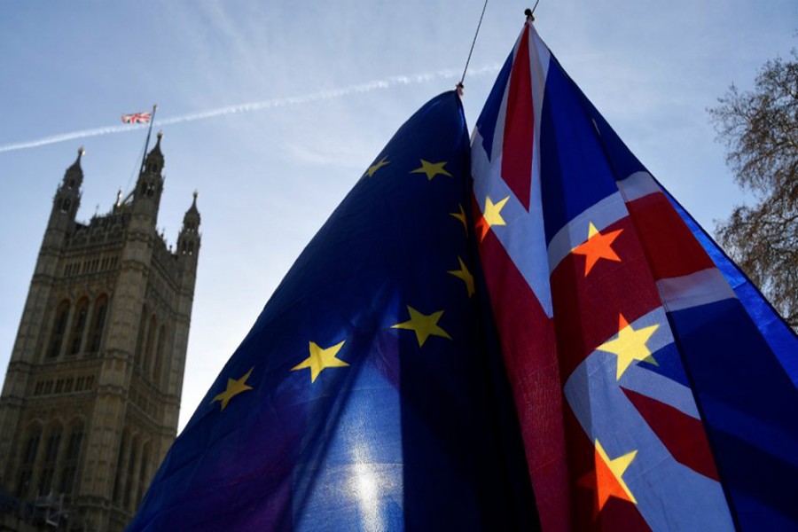 Demonstrators hold EU and Union flags during an anti-Brexit protest opposite the Houses of Parliament in London, Britain, December 17, 2018. Reuters/Files