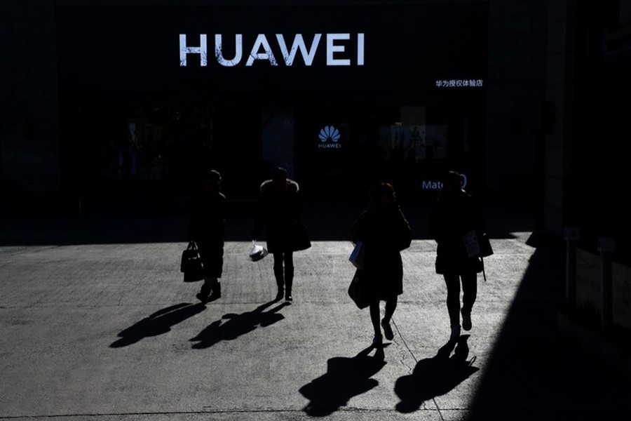 People walk past a Huawei shop in Beijing, China, December 11, 2018. Reuters/Files