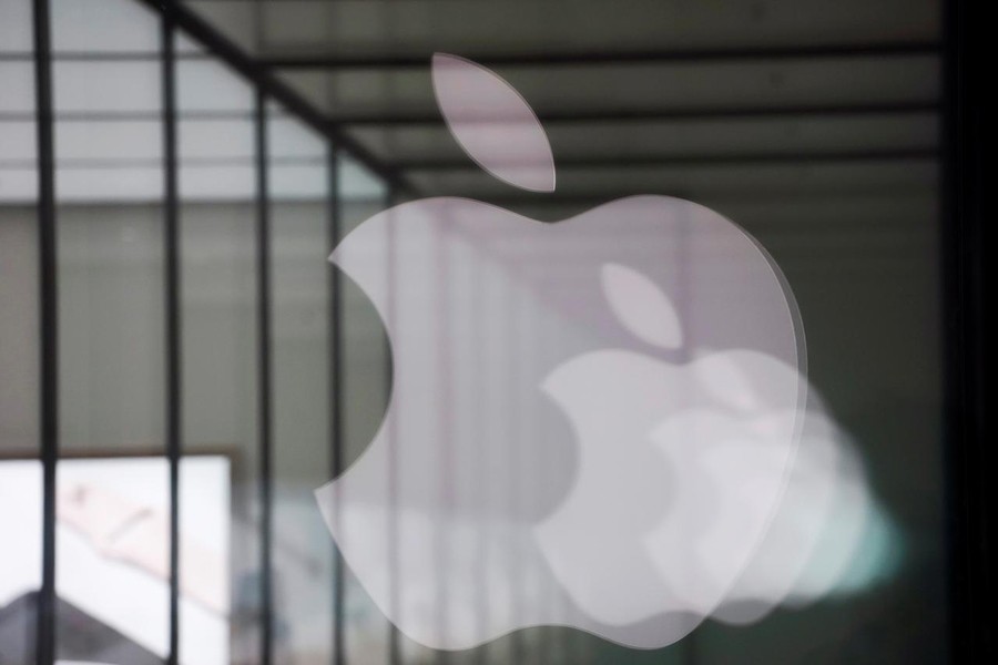 Apple company logos are reflected on the glass window outside an Apple store in Shanghai, China January 3, 2019. Reuters/Files