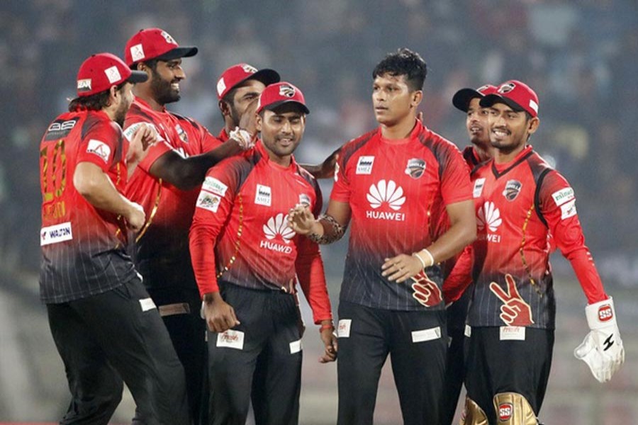 Comilla Victorians' Mohammad Saifuddin celebrating with his teammates after getting a wicket against Dhaka Dynamites in the BPL match at Sher-e-Bangla National Cricket Stadium in the city on Friday 	— bdnews24.com