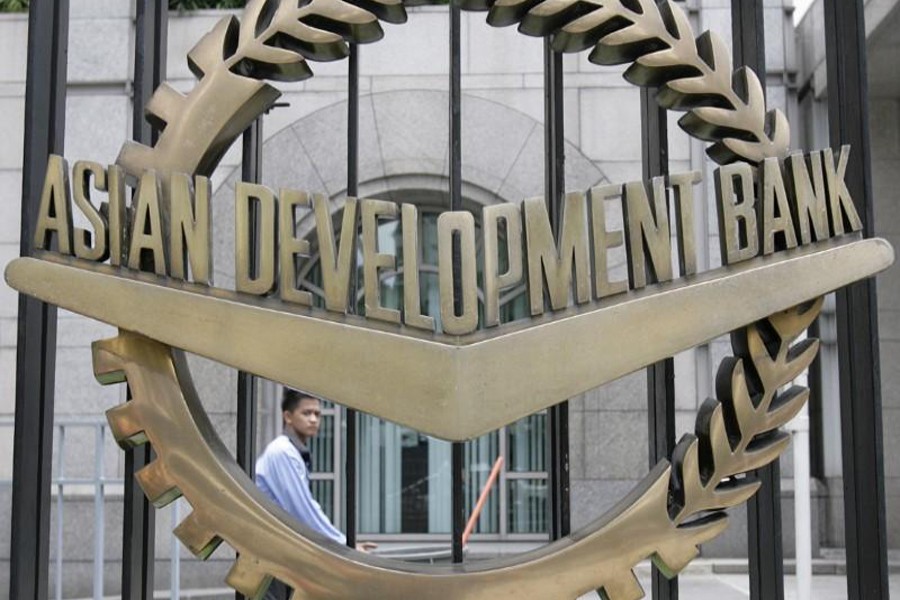 A worker walks past inside the Asian Development Bank (ADB) headquarters in Manila June 17, 2009. Reuters/Files