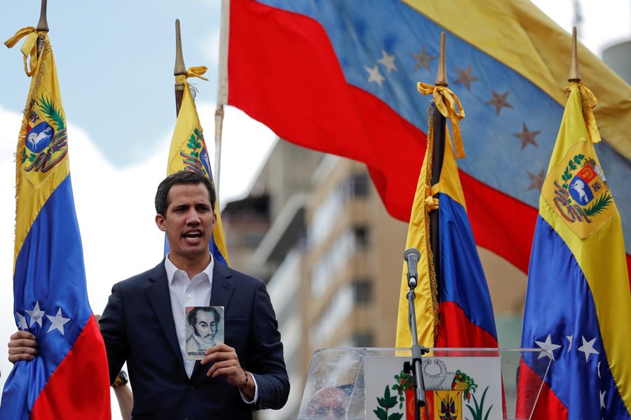Juan Guaido, President of Venezuela's National Assembly, holds a copy of Venezuelan constitution during a rally against Venezuelan President Nicolas Maduro's government and to commemorate the 61st anniversary of the end of the dictatorship of Marcos Perez Jimenez in Caracas, Venezuela January 23, 2019. Reuters/File Photo