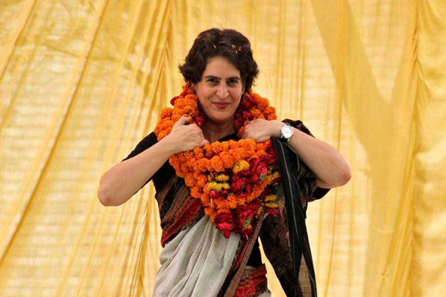 Priyanka Gandhi Vadra, daughter of India's ruling Congress party chief Sonia Gandhi, adjusts her flower garlands as she campaigns for her mother during an election meeting at Rae Bareli in the northern Indian state of Uttar Pradesh April 22, 2014. Reuters/Files