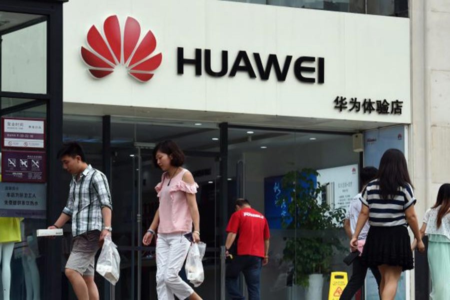 Customers walking past a Huawei shop in Beijing, China recently	 	— Reuters