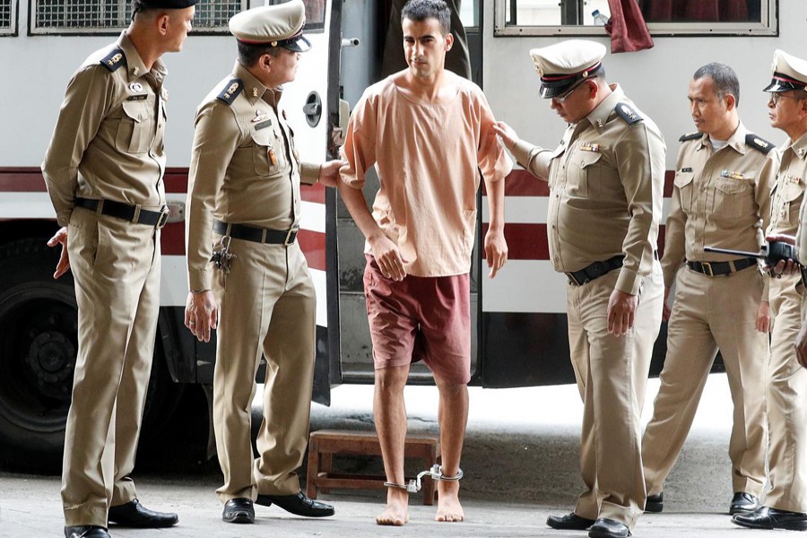 Feet shackled, Bahraini footballer arrives at Thai court to fight extradition