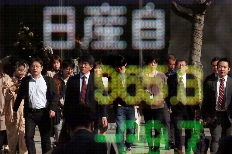 People are reflected in a stock quotation board showing share price of Nissan Motor Co outside a brokerage in Tokyo, Japan, November 20, 2018. Reuters