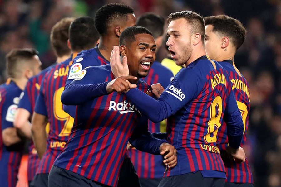 Malcom celebrates with his Barca teammates after scoring their lone goal against Real on Wednesday — Reuters photo