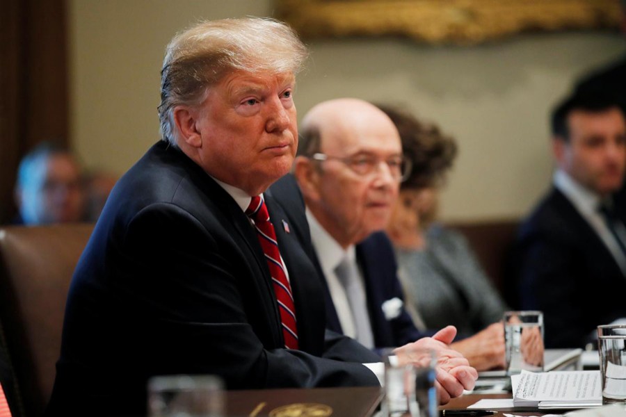US President Donald Trump listens next to Commerce Secretary Wilbur Ross during a Cabinet meeting at the White House in Washington, US, February 12, 2019. Reuters