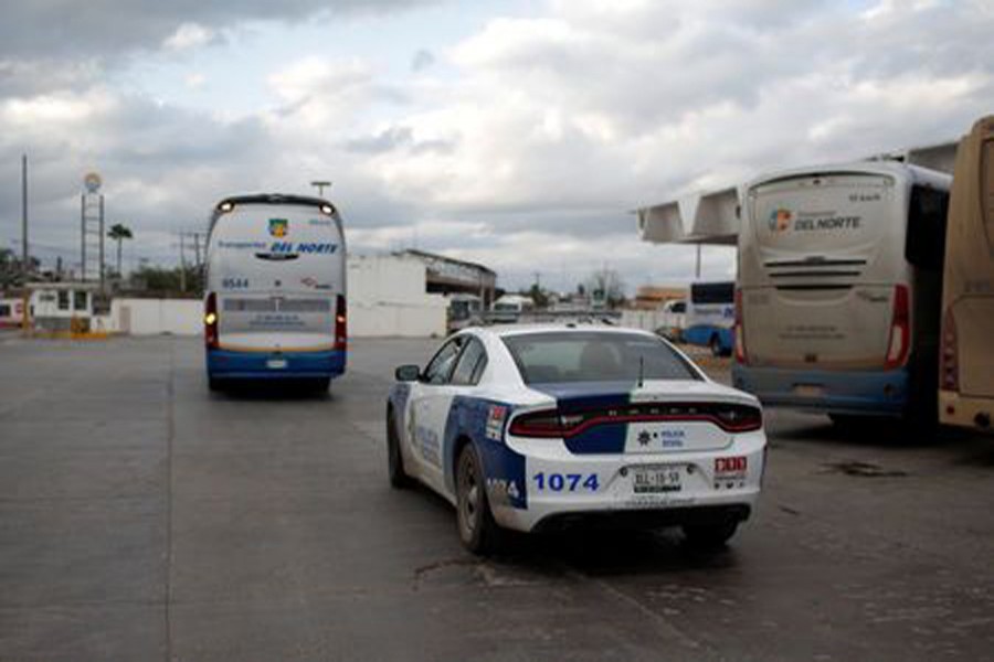 Police escort a bus bound to Monterrey, transporting Mexican migrants deported from the United States, as it leaves a bus station in Reynosa, Mexico, January 11, 2019. Reuters