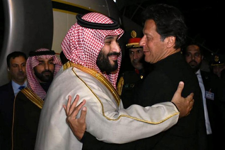 Pakistani Prime Minister Imran Khan (R) greets Saudi Arabia's Crown Prince Mohammed bin Salman on his arrival at Pakistan Air Force (PAF) Nur Khan Base in Rawalpindi, Pakistan on Sunday — Press Information Department (PID)/Handout via Reuters