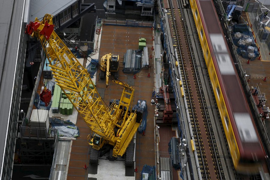 Heavy machineries are seen next to a subway train at a construction site in Tokyo, Japan, March 13, 2016. REUTERS/Yuya Shino