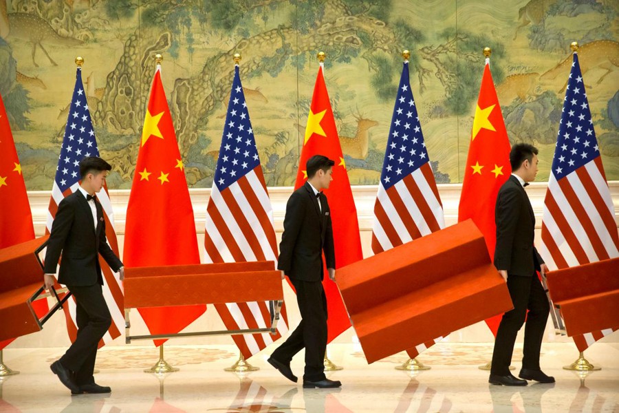 Aides set up platforms before a group photo with members of US and Chinese trade negotiation delegations at the Diaoyutai State Guesthouse in Beijing, China, February 15, 2019. Reuters