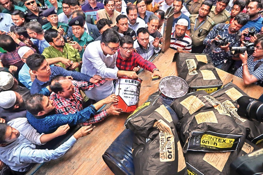 Dhaka South Mayor Sayeed Khokon and others helping in loading a truck with chemicals being transfered from the basement of the Hazi Wahid Manzil at the city’s Chawkbazaron Saturday — FE photo