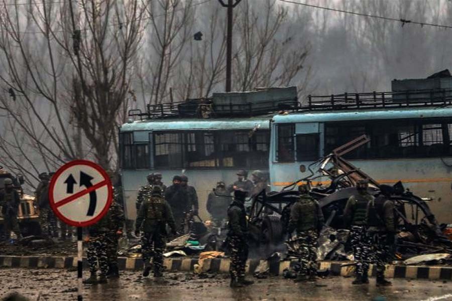 Security personnel carry out rescue and relief operations on the Jammu-Srinagar highway after the deadly terror attack on February 14, 2019.    —Photo by PTI