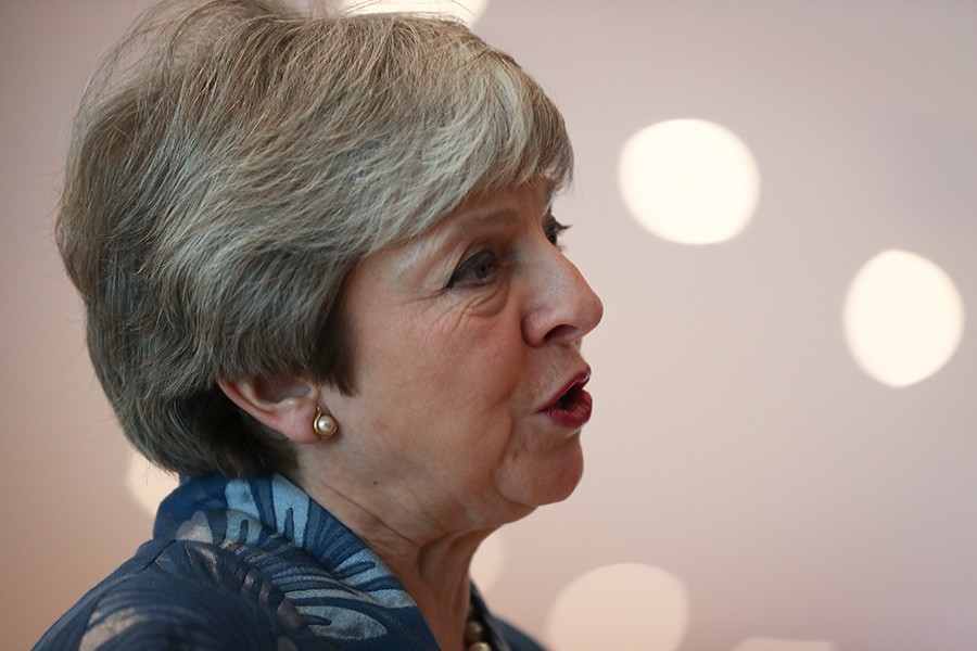 British Prime Minister Theresa May speaks with the media as she arrives for an EU-Arab summit at the Sharm El Sheikh convention center in Sharm El Sheikh, Egypt on Sunday — AP photo