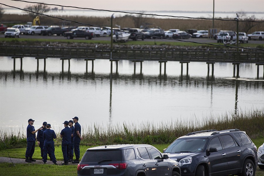 Local and federal officials gather at a staging area during the investigation of a plane crash in Trinity Bay in Anahuac, Texas on Saturday — AP photo