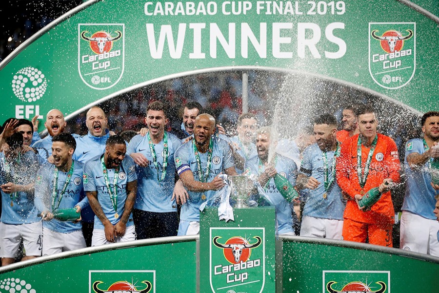 Manchester City's Vincent Kompany and teammates celebrate with the trophy after the match — Reuters photo