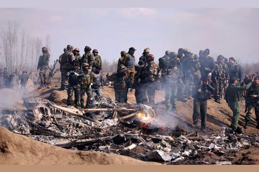 Indian soldiers stand next to the wreckage of Indian Air Force's helicopter after it crashed in Budgam district in Kashmir February 27, 2019 - REUTERS/Danish Ismail