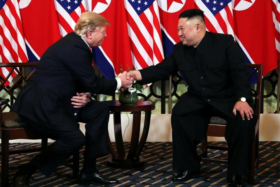 US President Donald Trump and North Korean leader Kim Jong Un shaking hands to mark the start of their second meeting in Hanoi on Wednesday. -Reuters Photo