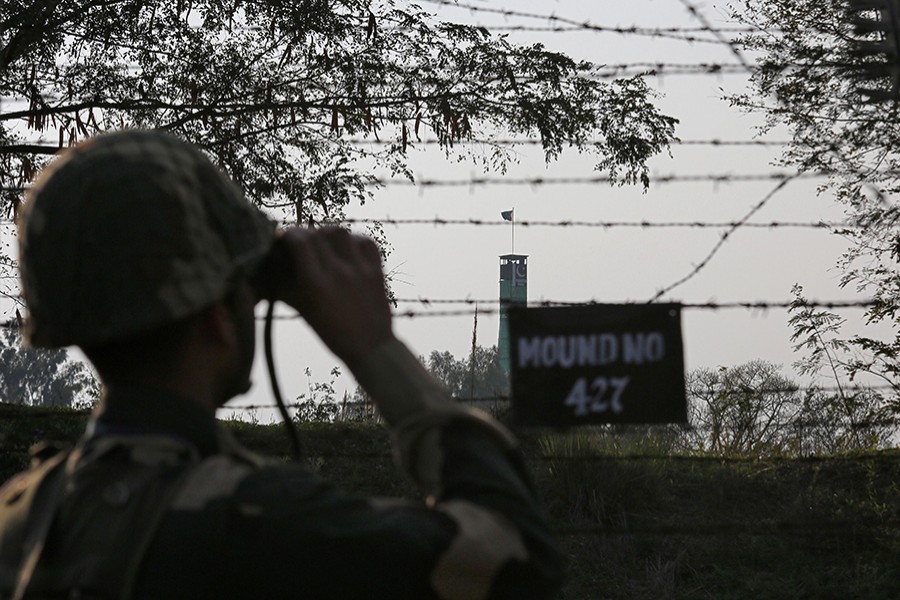 An India's Border Security Force (BSF) soldier keeps vigil during patrol along the fenced border with Pakistan in Ranbir Singh Pura sector near Jammu on Tuesday — Reuters photo