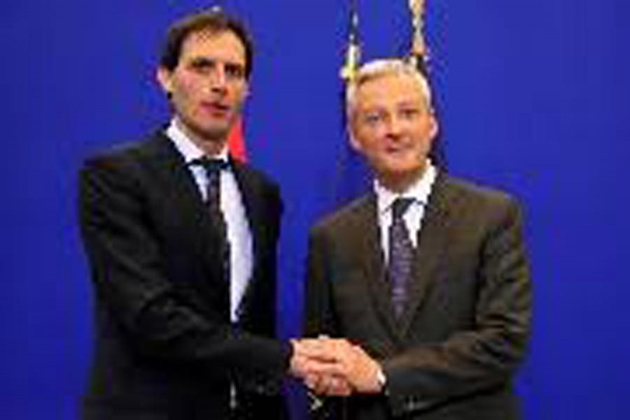 French Finance Minister Bruno Le Maire and Dutch Finance Minister Wopke Hoekstra shaking hands during a joint news conference at the Bercy Finance Ministry in Paris, France on Friday 	— Reuters