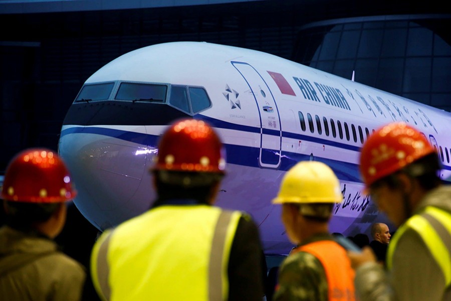 Workers attend a ceremony marking the 1st delivery of a Boeing 737 Max 8 airplane to Air China at the Boeing Zhoushan completion centre in Zhoushan, Zhejiang province, China on December 15, 2018. — Reuters/file