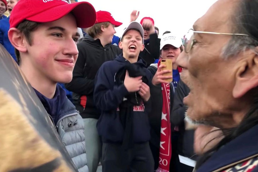 Nicholas Sandmann, 16, a student from Covington Catholic High School stands in front of Native American activist Nathan Phillips in Washington, US, in this still image from a January 18, 2019 video by Kaya Taitano - Kaya Taitano/Social Media/via REUTERS/File Photo