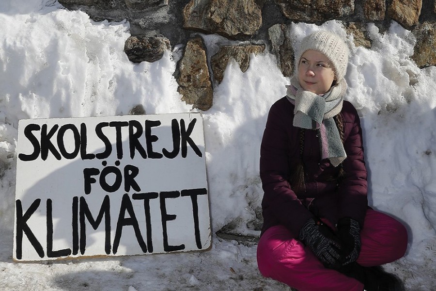 Teen climate activist Greta Thunberg of Sweden poses for media outside the congress centre where the World Economic Forum take place in Davos, Switzerland on Friday, January 25, 2019. The poster reads: 'School strike for the climate'.             —Photo: AP