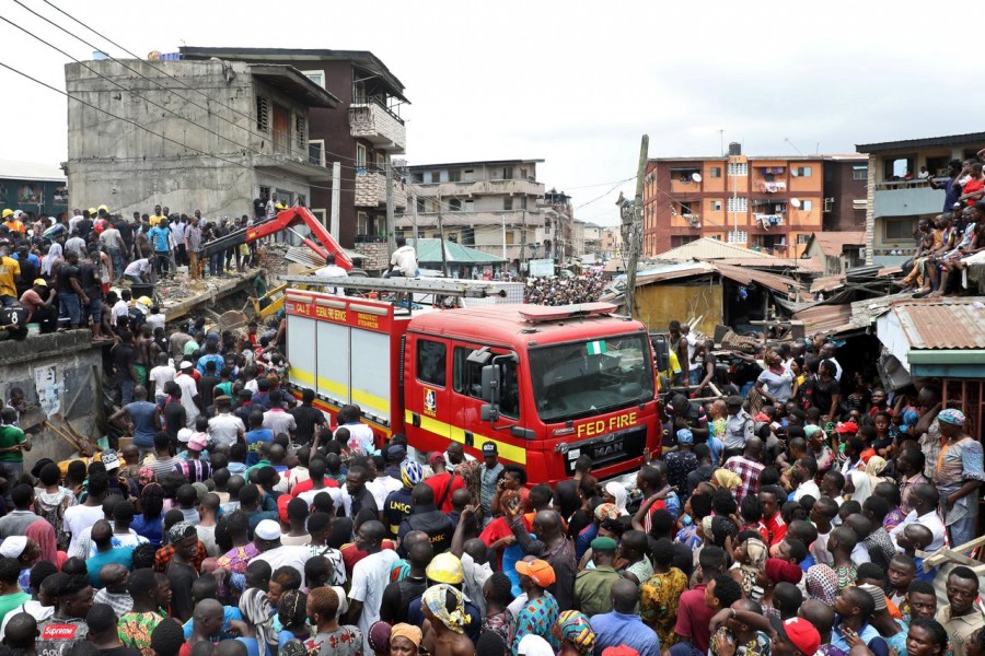 People gather as rescue workers search for survivors at the site of a collapsed building containing a school in Nigeria's commercial capital of Lagos, Nigeria March 13, 2019 - REUTERS/Temilade Adelaja