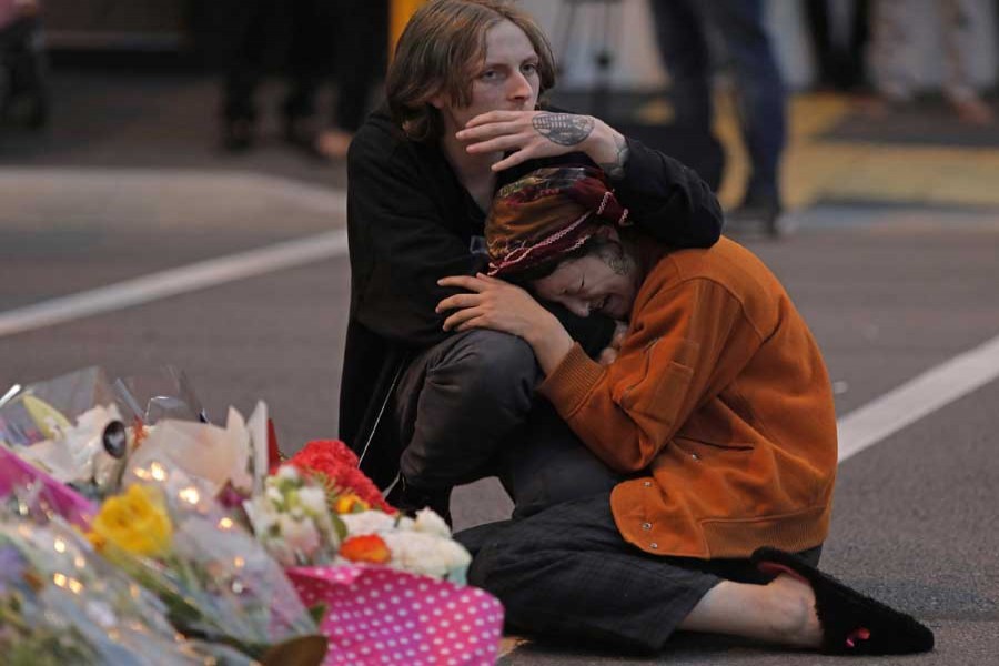 Mourners pay their respects at a makeshift memorial near the Masjid Al Noor mosque in Christchurch, New Zealand, Saturday, March 16, 2019. - AP