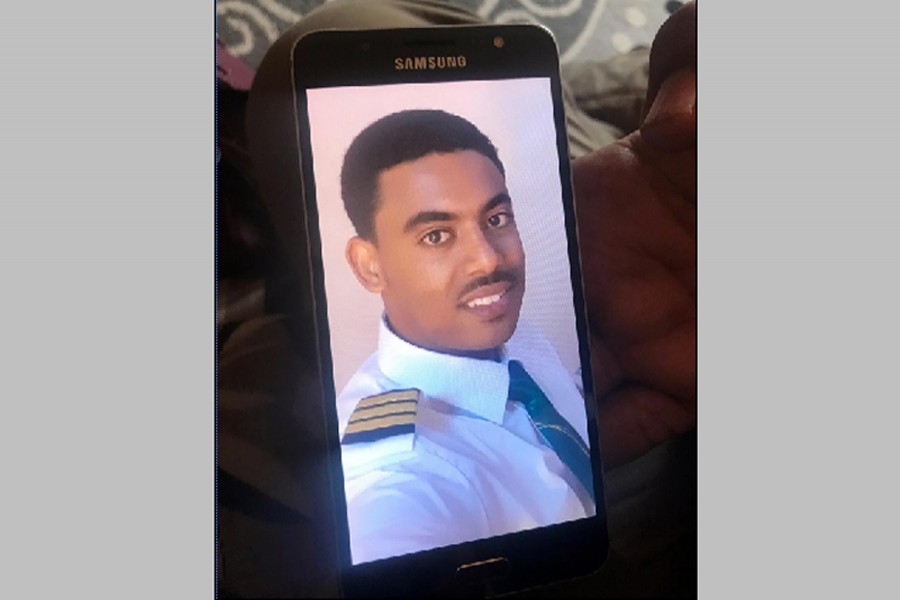 Menur Mohamed, brother to Ethiopian Airlines ET 302 First Officer Ahmednur Mohamed, holds his phone with a photograph of his brother during a Reuters interview in Addis Ababa, March 17, 2019. Reuters