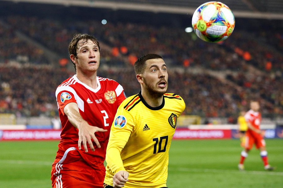 Belgium's Eden Hazard in action with Russia's Mario Fernandes — Reuters photo