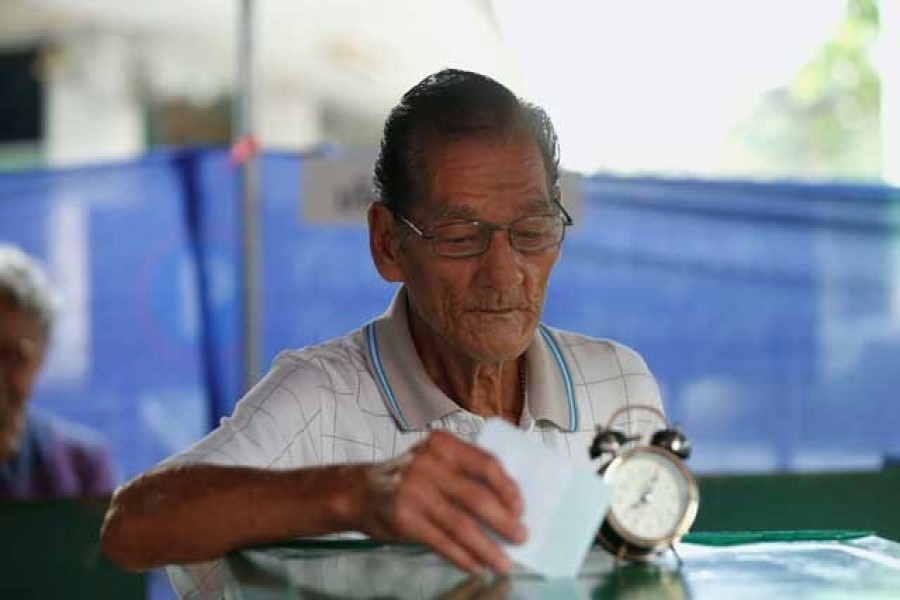 A voter casts his ballot in the general election at a polling station in Bangkok, Thailand, March 24, 2019. Reuters