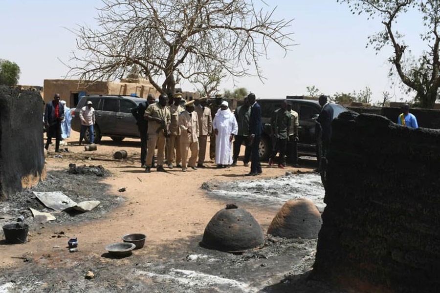 Mali's President Ibrahim Boubacar Keita inspects the damage after an attack by gunmen on Fulani herders in Ogossagou, Mali - Reuters