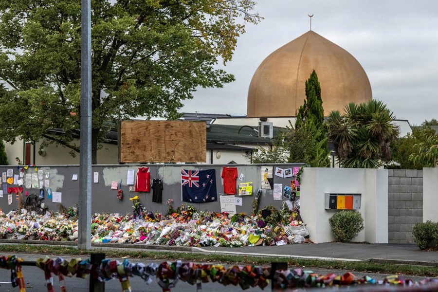 People leave messages and flowers for the victims of the Christchurch mosque attacks outside the mosque in Christchurch, New Zealand