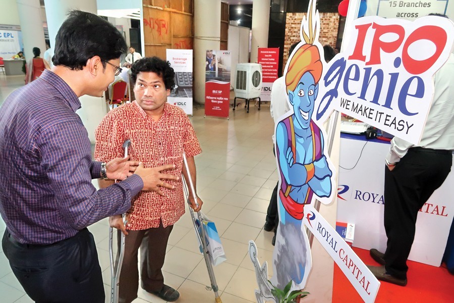 An exhibitor explaining his product to a visitor at the three-day Capital Market Expo which began at Shilpakala Academy in the city on Thursday— FE photo