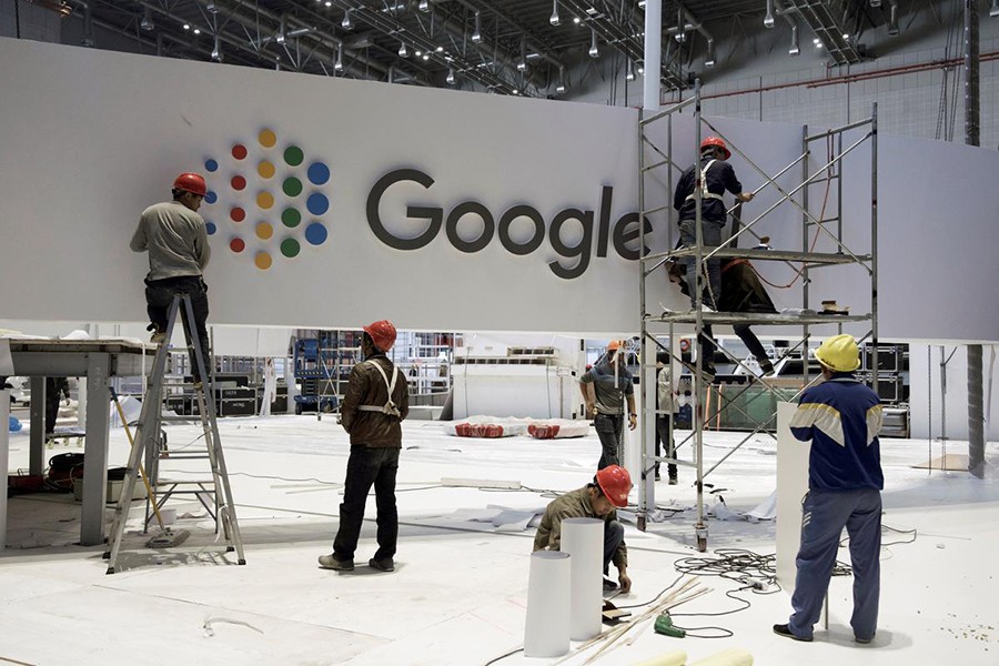 Workers set up the booth for Alphabet's Google inside the National Exhibition and Convention Center in Shanghai, China on October 28, 2018 — China Daily photo via Reuters